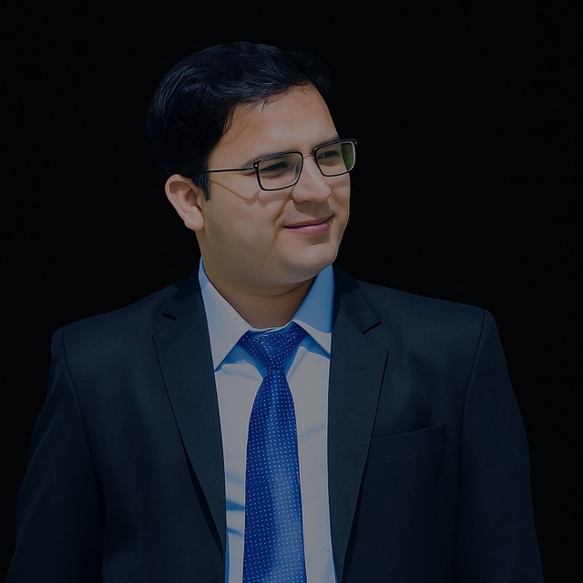 Portrait of Sagar Tripathi in a dark suit and blue tie